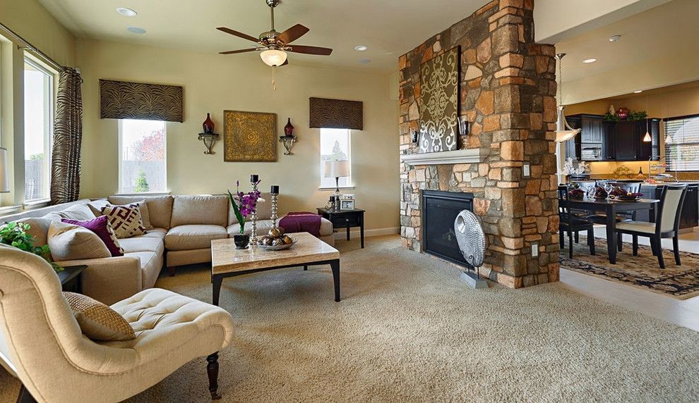 Medium sized traditional formal open plan living room in New York with beige walls, carpet, a two-sided fireplace and a stone fireplace surround.