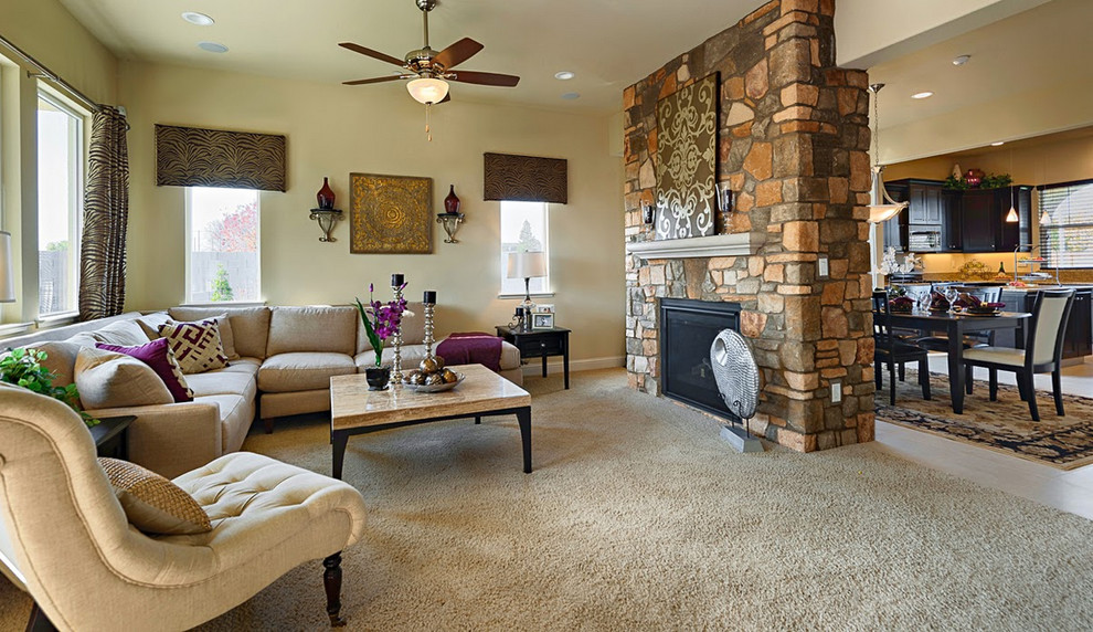 Photo of a large traditional formal open plan living room in Cleveland with beige walls, carpet, a standard fireplace and a stone fireplace surround.