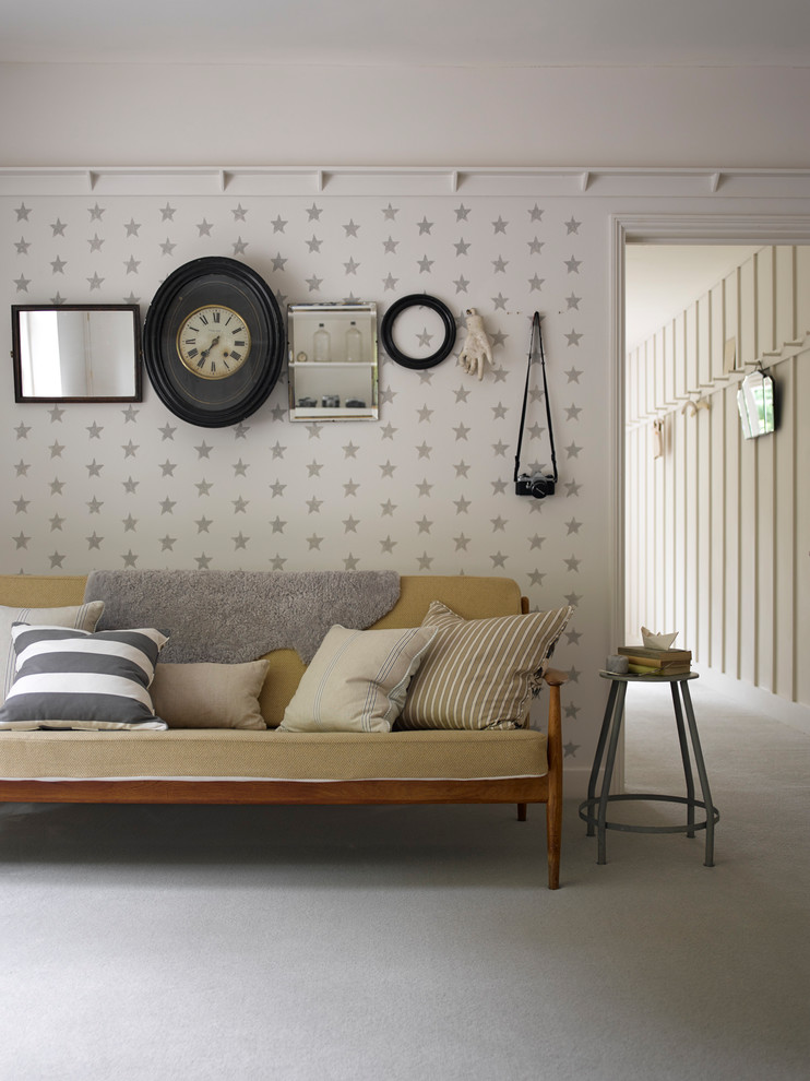 Photo of a retro living room in London with white walls, carpet and grey floors.