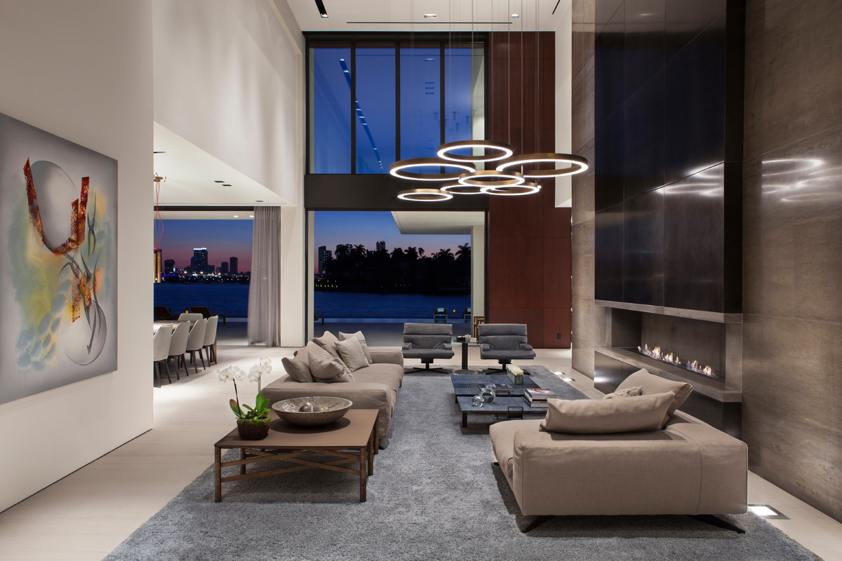 Living room - contemporary open concept gray floor living room idea in Miami with white walls and a ribbon fireplace