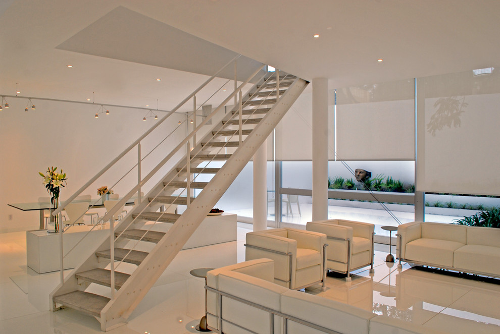 This is an example of a contemporary open plan living room in Mexico City with white walls.