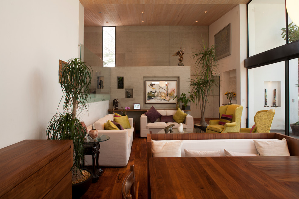 Example of a trendy medium tone wood floor living room design in Mexico City with white walls