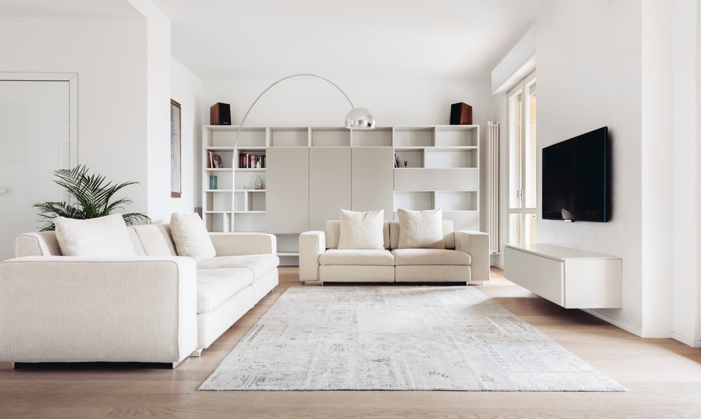 Modernes Wohnzimmer mit hellem Holzboden und TV-Wand in Mailand
