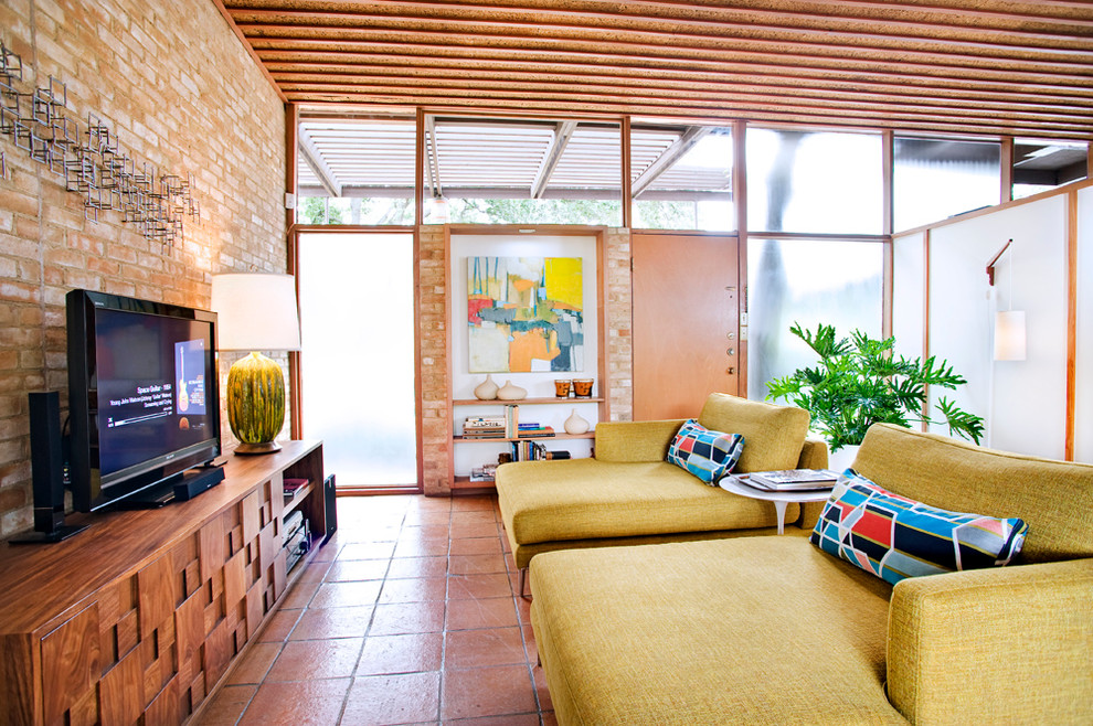 Inspiration for a midcentury living room in Austin with terracotta flooring.