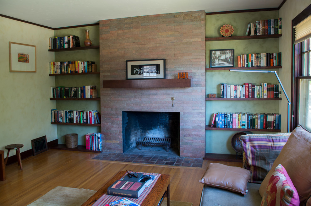 Cette photo montre un petit salon tendance ouvert avec un mur vert, un sol en bois brun, une cheminée standard, un manteau de cheminée en carrelage et un téléviseur indépendant.