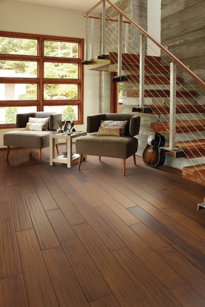 Large trendy open concept medium tone wood floor living room photo in Jacksonville with beige walls and no tv