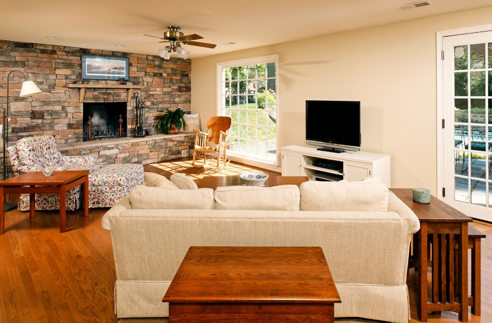 Photo of a traditional living room feature wall in DC Metro with a stone fireplace surround.
