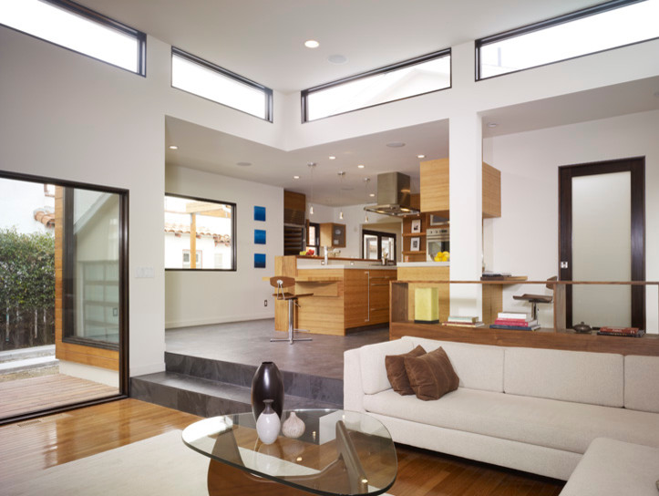 Foto di un grande soggiorno moderno aperto con pareti bianche e pavimento in legno massello medio