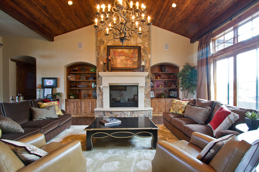 Example of a mid-sized mountain style formal and open concept dark wood floor living room design in Denver with beige walls, a standard fireplace, a stone fireplace and no tv