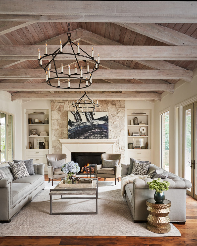 This is an example of a large traditional open plan living room in Other with medium hardwood flooring, a standard fireplace, a stone fireplace surround, brown floors and beige walls.