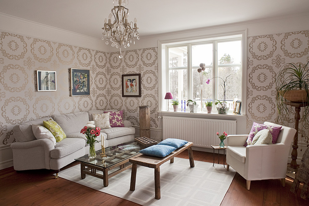 Inspiration for a mid-sized eclectic formal and enclosed medium tone wood floor living room remodel in Stockholm with beige walls, no fireplace and no tv