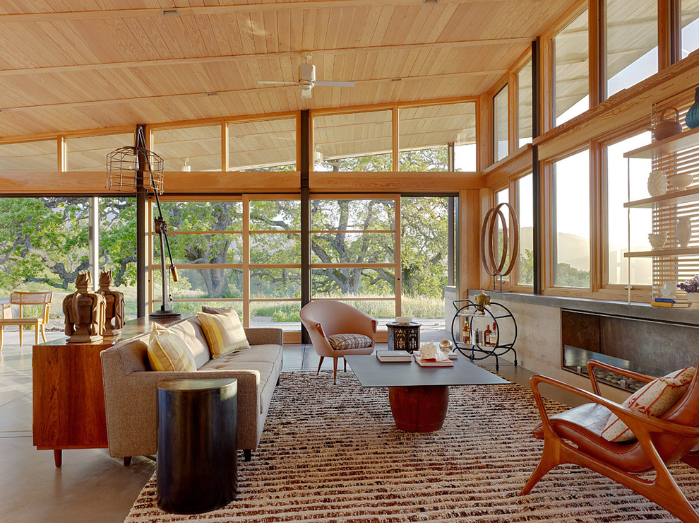 Danish open concept concrete floor living room photo in San Francisco with a ribbon fireplace and no tv