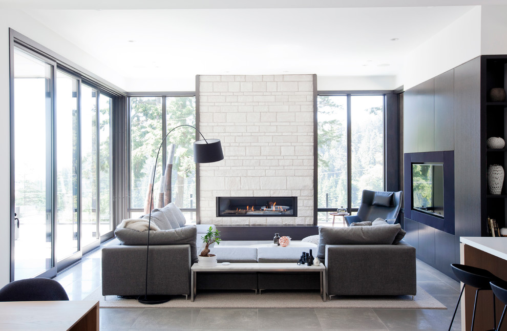 Living room - large contemporary open concept porcelain tile living room idea in Vancouver with white walls, a standard fireplace, a stone fireplace and a media wall