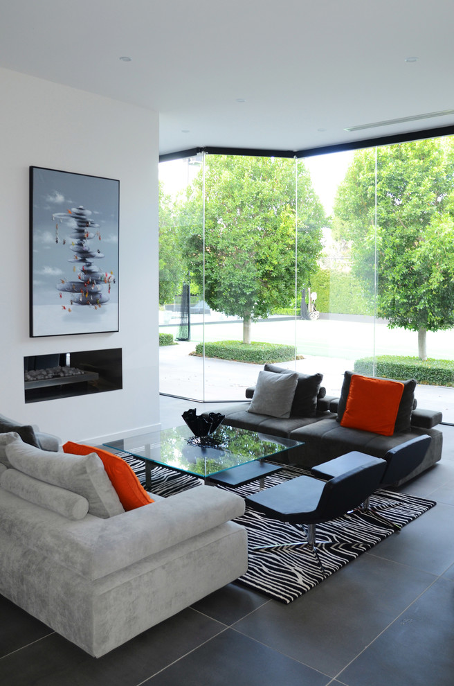 Photo of a contemporary living room in Melbourne with white walls and a ribbon fireplace.