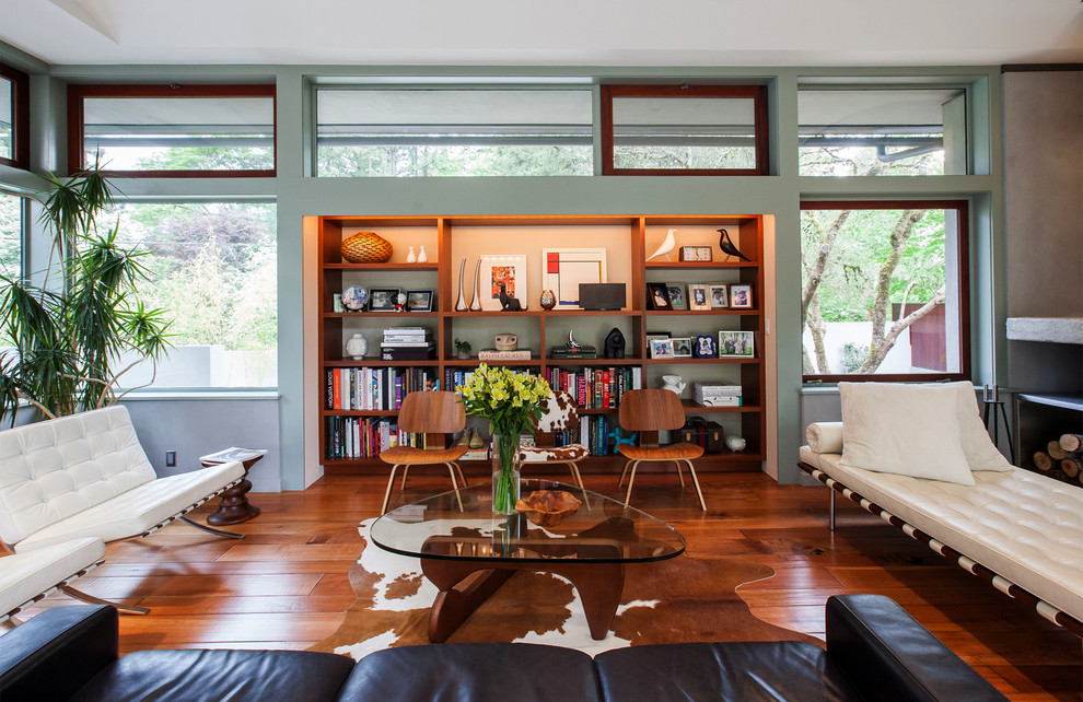 Midcentury living room in Portland with green walls and dark hardwood flooring.
