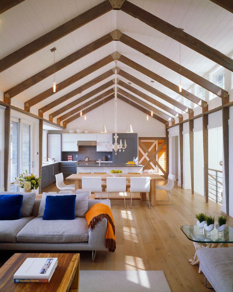 Mid-sized beach style open concept light wood floor living room photo in Boston with white walls and no fireplace