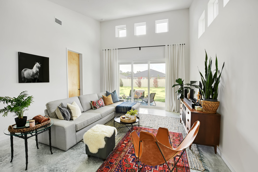 Living room - mid-sized modern open concept concrete floor and gray floor living room idea in Jacksonville with white walls, no fireplace and a tv stand