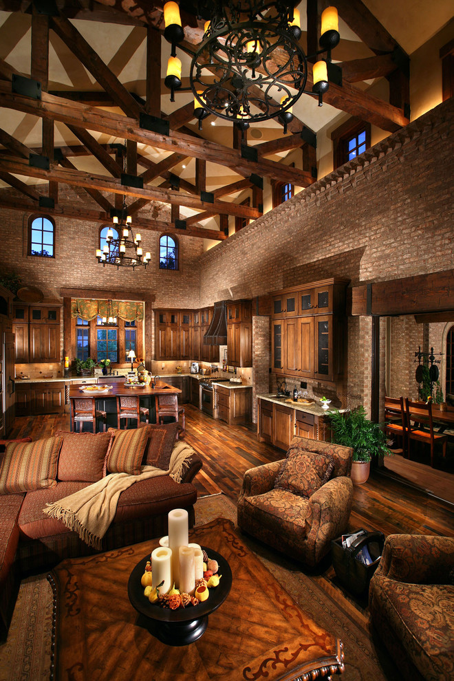 Mediterranean open plan living room in Denver with dark hardwood flooring.