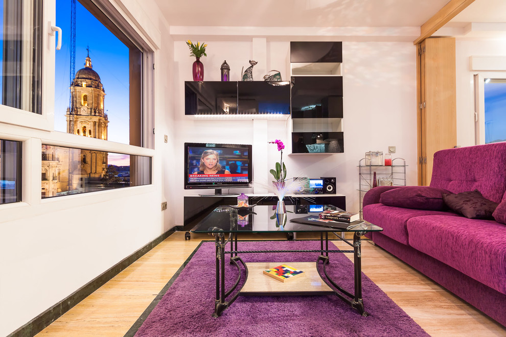 Small transitional light wood floor living room photo in Malaga with white walls and a tv stand