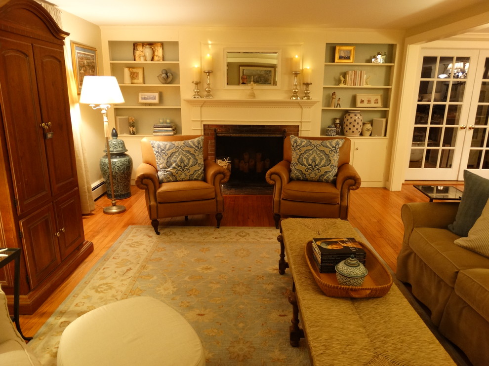 This is an example of a medium sized classic enclosed living room in Boston with beige walls, light hardwood flooring, a standard fireplace and a brick fireplace surround.