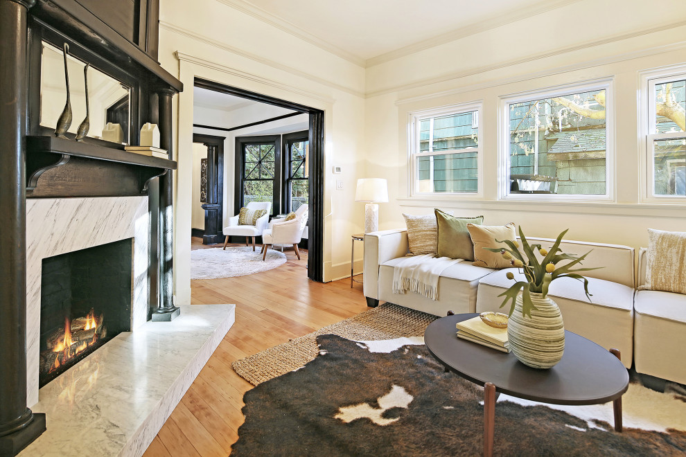 Example of a mid-sized arts and crafts formal and enclosed medium tone wood floor and brown floor living room design in Seattle with white walls, a standard fireplace and no tv