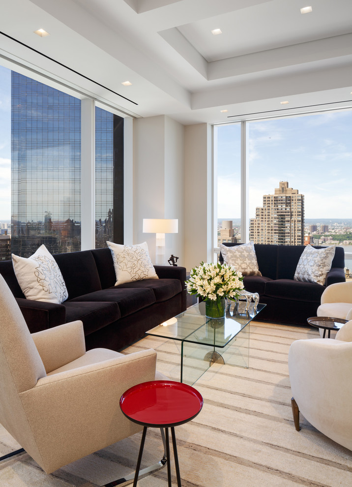 Example of a trendy carpeted living room design in New York with white walls and a media wall