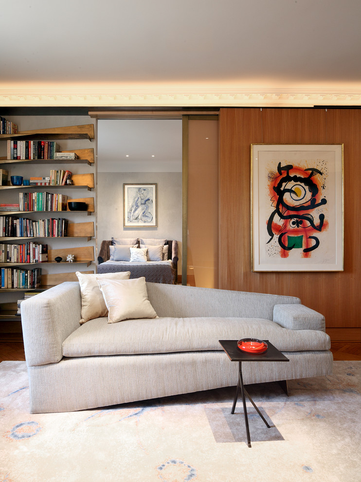 This is an example of a contemporary living room in New York with brown walls and medium hardwood flooring.