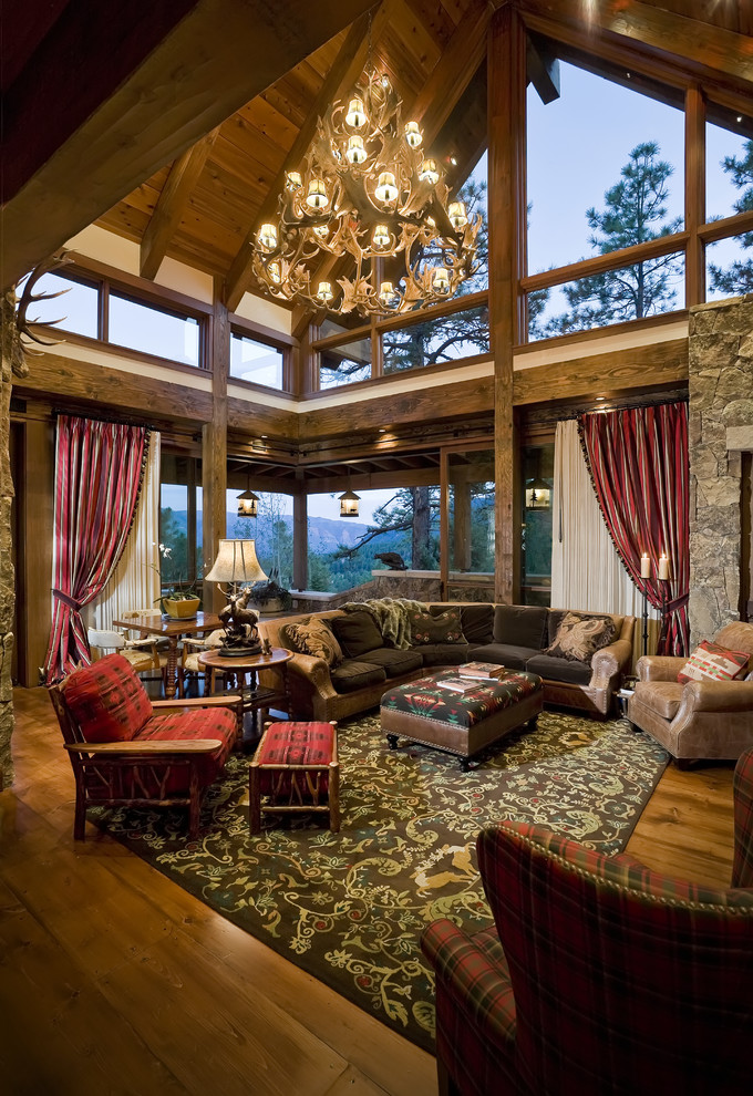 Mid-sized mountain style enclosed medium tone wood floor, brown floor and vaulted ceiling living room photo in Other with white walls, no fireplace and no tv