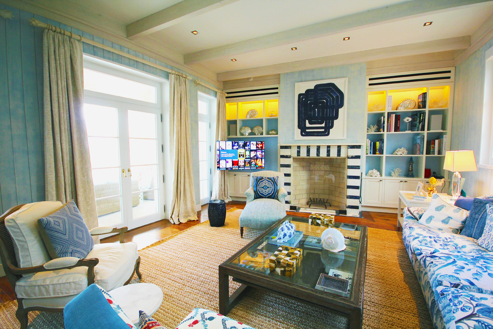 Aménagement d'un salon contemporain de taille moyenne avec un mur bleu, un sol en bois brun, un manteau de cheminée en carrelage et un téléviseur fixé au mur.