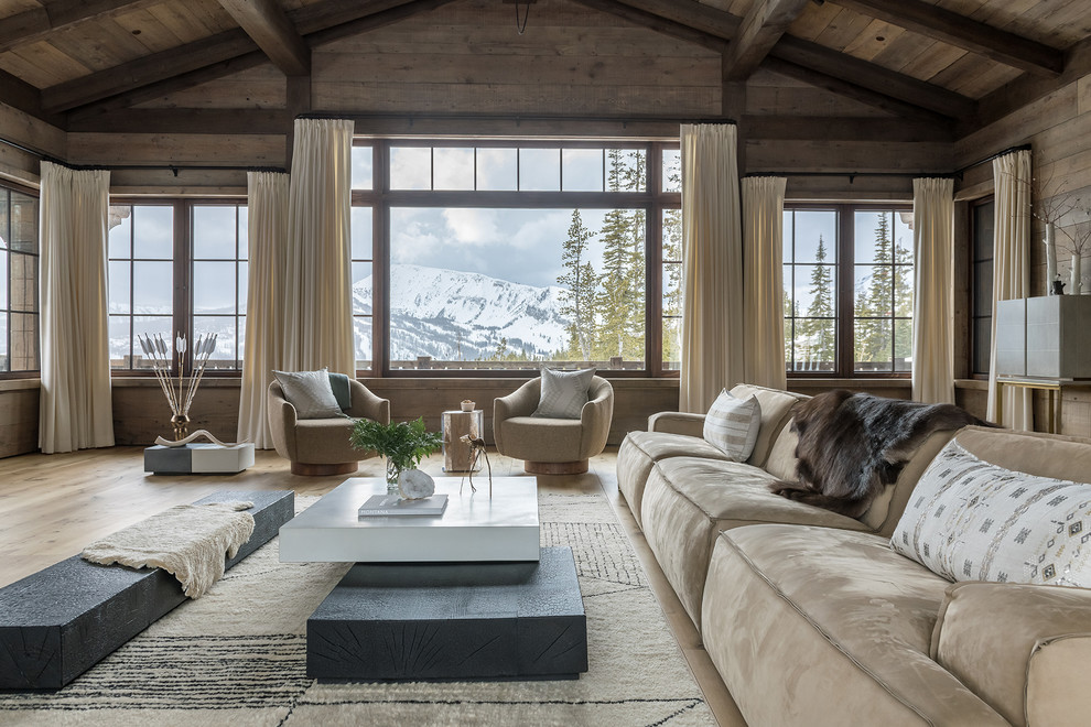 Rustic living room in Other with brown walls, light hardwood flooring and beige floors.