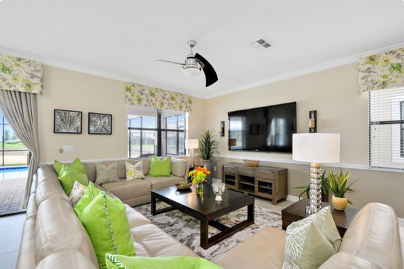 Photo of a large eclectic enclosed living room in Orlando with beige walls, porcelain flooring and a wall mounted tv.