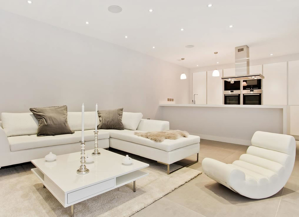 Trendy formal and open concept light wood floor living room photo in London with white walls