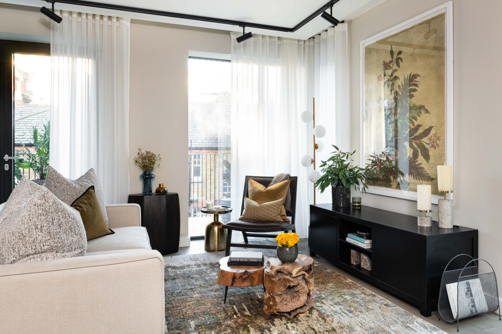 This is an example of a large contemporary formal open plan living room in London with beige walls and grey floors.