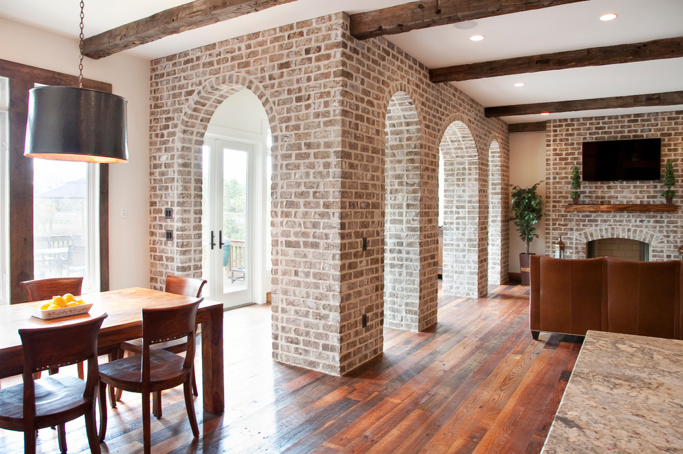 Inspiration for a traditional living room in Charleston with a standard fireplace and a brick fireplace surround.