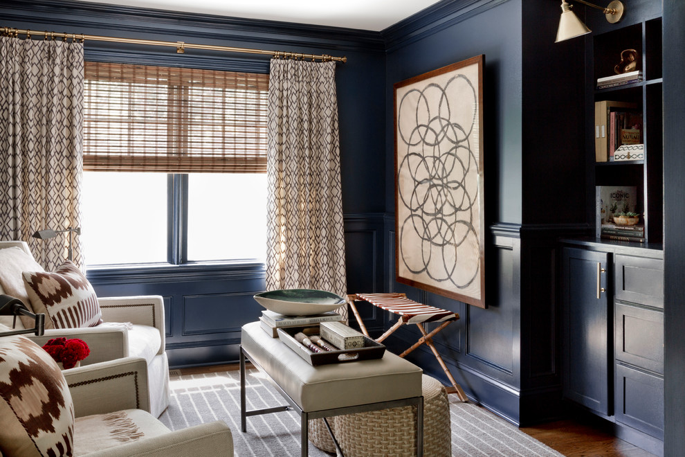 Inspiration for an eclectic enclosed living room in New York with a reading nook, blue walls and a built-in media unit.