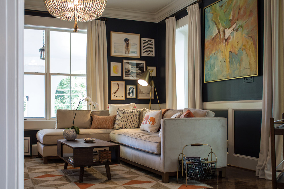 Photo of a traditional living room in Nashville with blue walls and dark hardwood flooring.