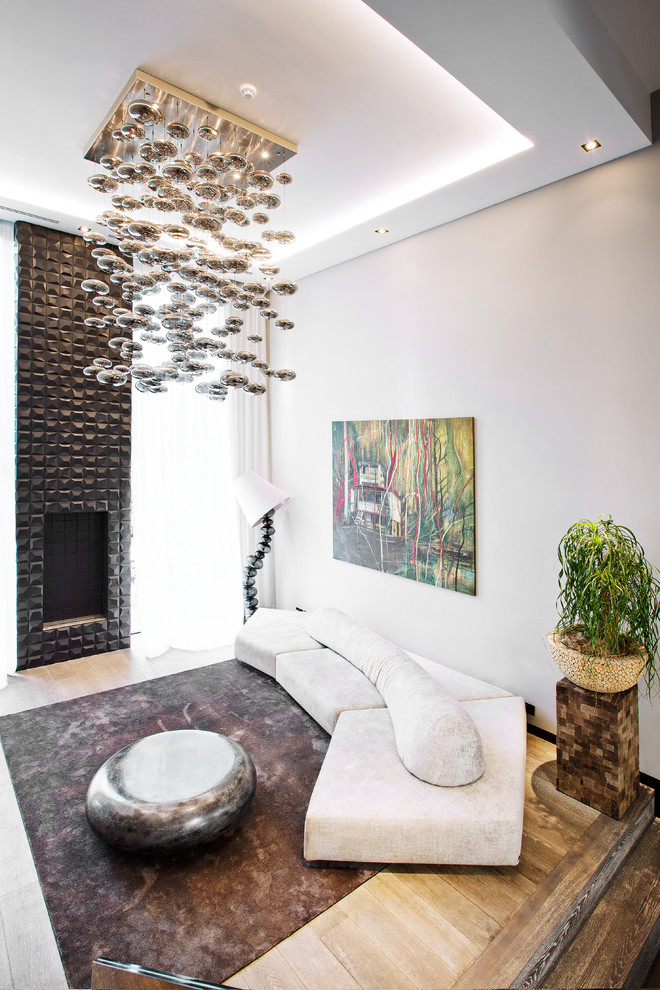 Источник вдохновения для домашнего уюта: гостиная комната в стиле модернизм с серыми стенами, светлым паркетным полом, стандартным камином и бежевым полом
