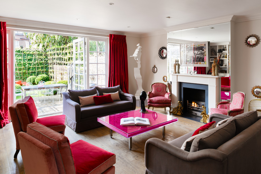 Transitional living room photo in London with beige walls and a standard fireplace