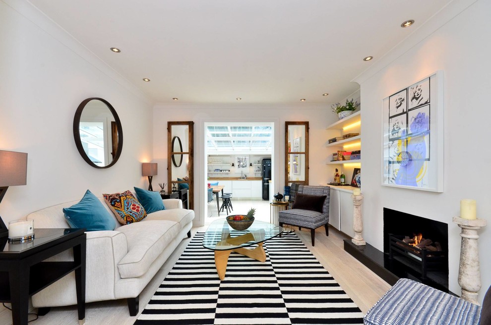 Medium sized contemporary living room in London with white walls, a standard fireplace and a stone fireplace surround.