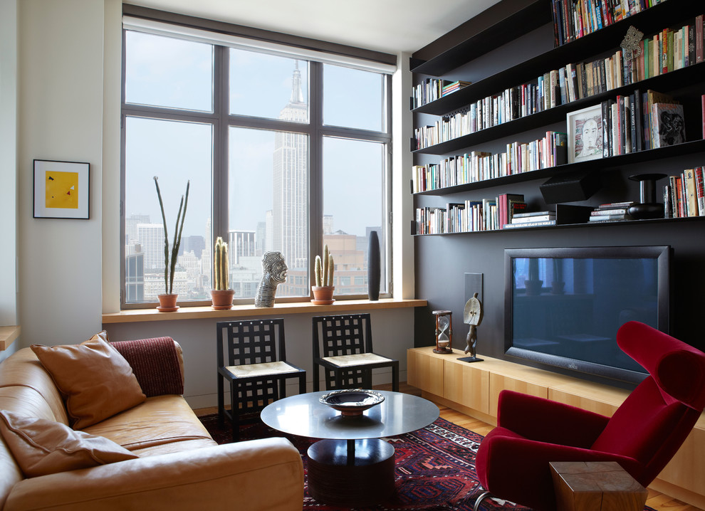 Inspiration for a small contemporary enclosed light wood floor living room remodel in New York with black walls and no fireplace