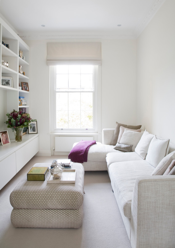 Trendy enclosed carpeted living room photo in London with white walls