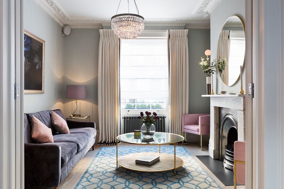 Living room - transitional enclosed and formal light wood floor and beige floor living room idea in London with a standard fireplace, a stone fireplace, blue walls and no tv