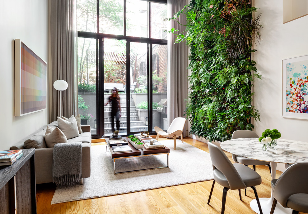 Danish open concept medium tone wood floor living room photo in New York with white walls, no fireplace and no tv