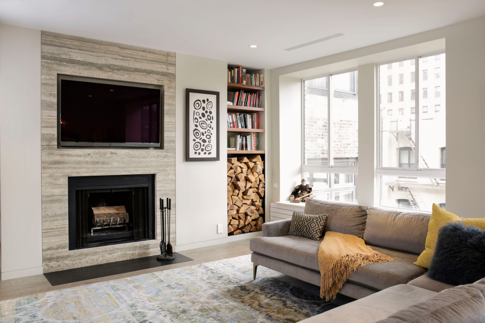 Design ideas for a contemporary open plan living room in New York with white walls, medium hardwood flooring, a standard fireplace, a wall mounted tv and brown floors.