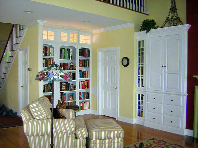 Living room library - mid-sized traditional open concept light wood floor living room library idea in Baltimore with yellow walls