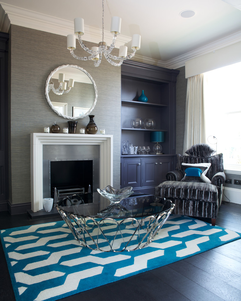 Elegant dark wood floor and black floor living room photo in Manchester with gray walls, a standard fireplace and a metal fireplace