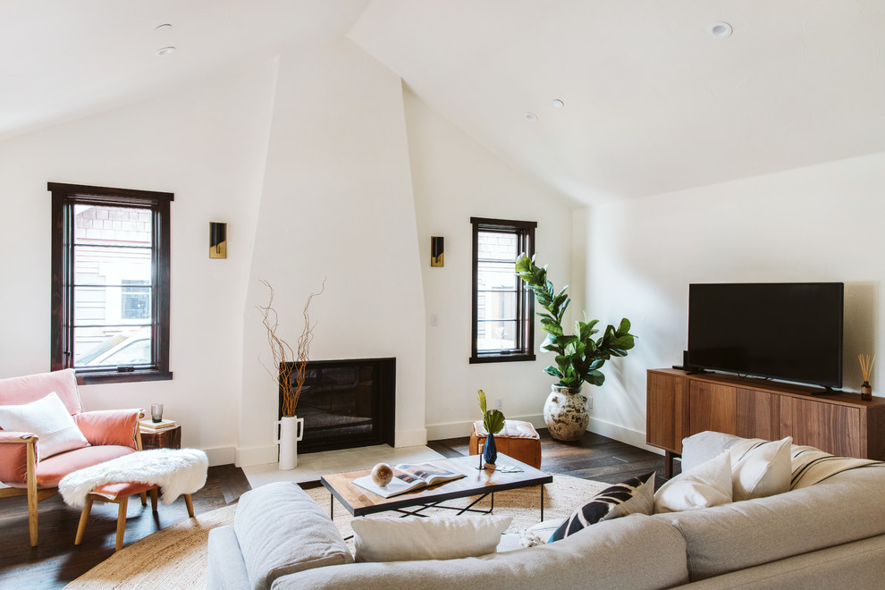 Inspiration for a contemporary open concept dark wood floor and brown floor living room remodel in Los Angeles with white walls, a standard fireplace, a plaster fireplace and a tv stand
