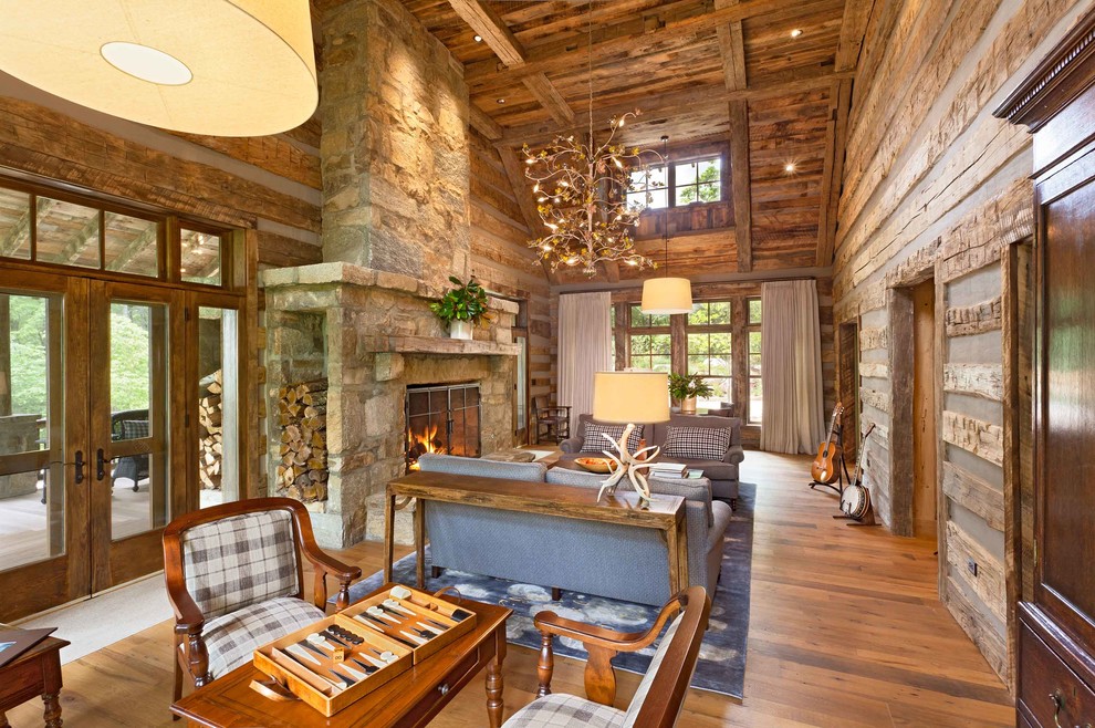 Rustic living room in Other with a music area, a standard fireplace, a stone fireplace surround and no tv.