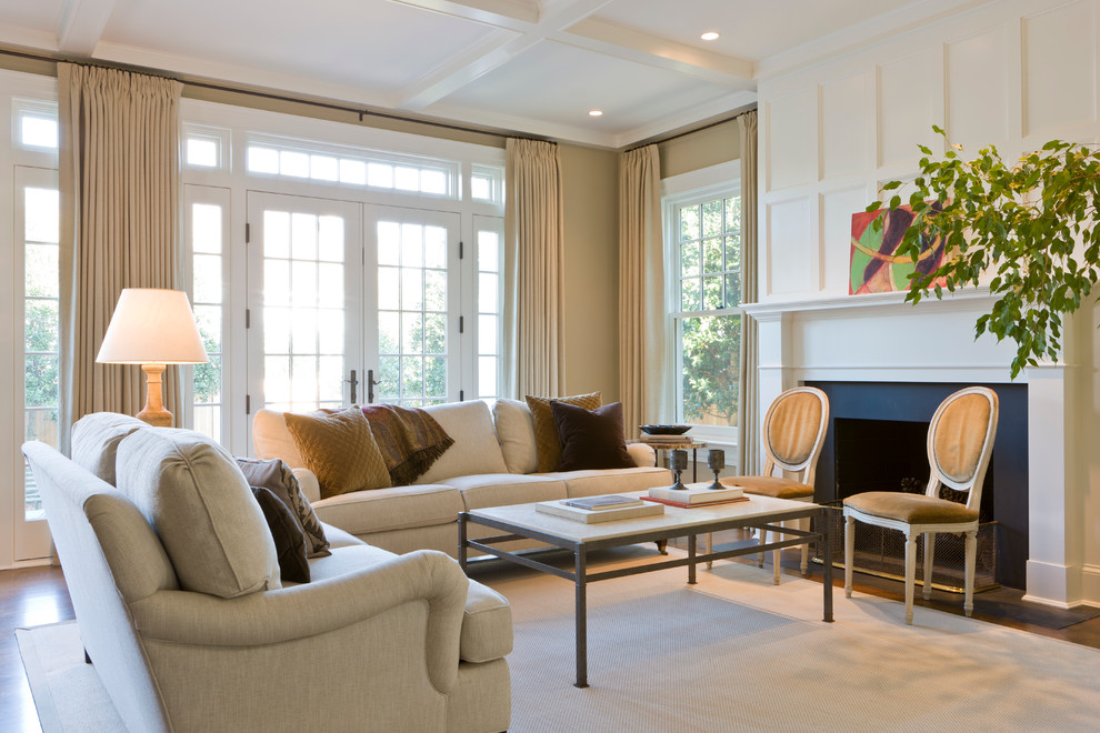 Elegant living room photo in DC Metro with beige walls and a standard fireplace