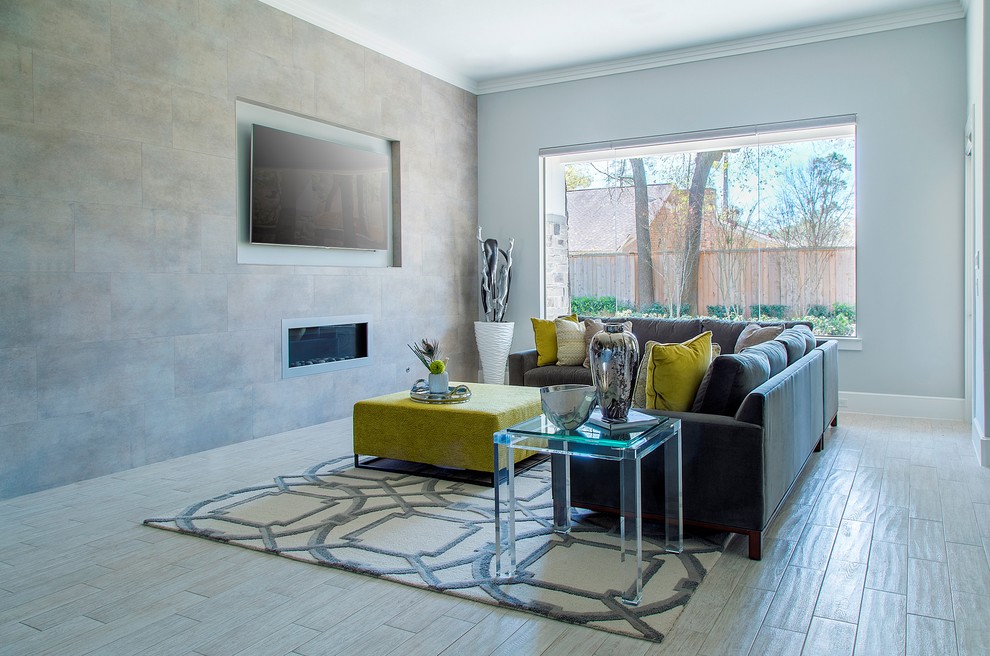 Large trendy open concept porcelain tile living room photo in Other with gray walls, a metal fireplace, a wall-mounted tv and a ribbon fireplace